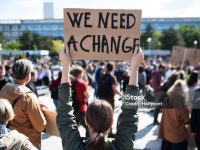 A rear view of people with placards and posters on global strike for climate change.